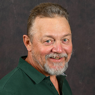 Profile photo of Darrin Totty, lead mechanic and relief supervisor, in front of a professional backdrop.