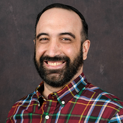 Profile photo of John Davis, a Director of Extended Campus, in front of a professional backdrop.