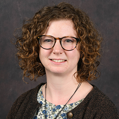 Profile photo of Madison Policelli, transcript analyst, in front of a professional backdrop.