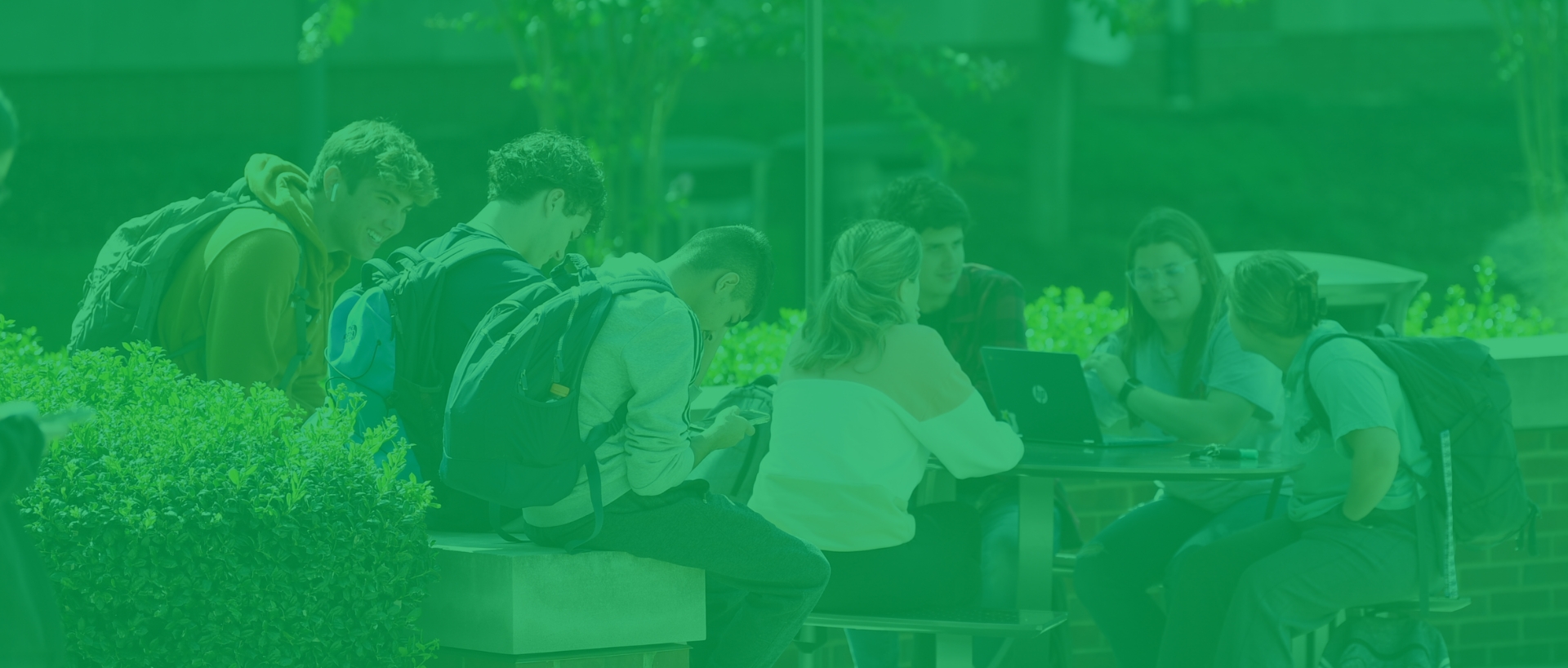 Students sitting at table outside