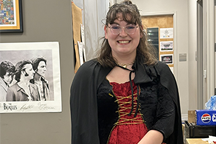 Student in red dress with black robe